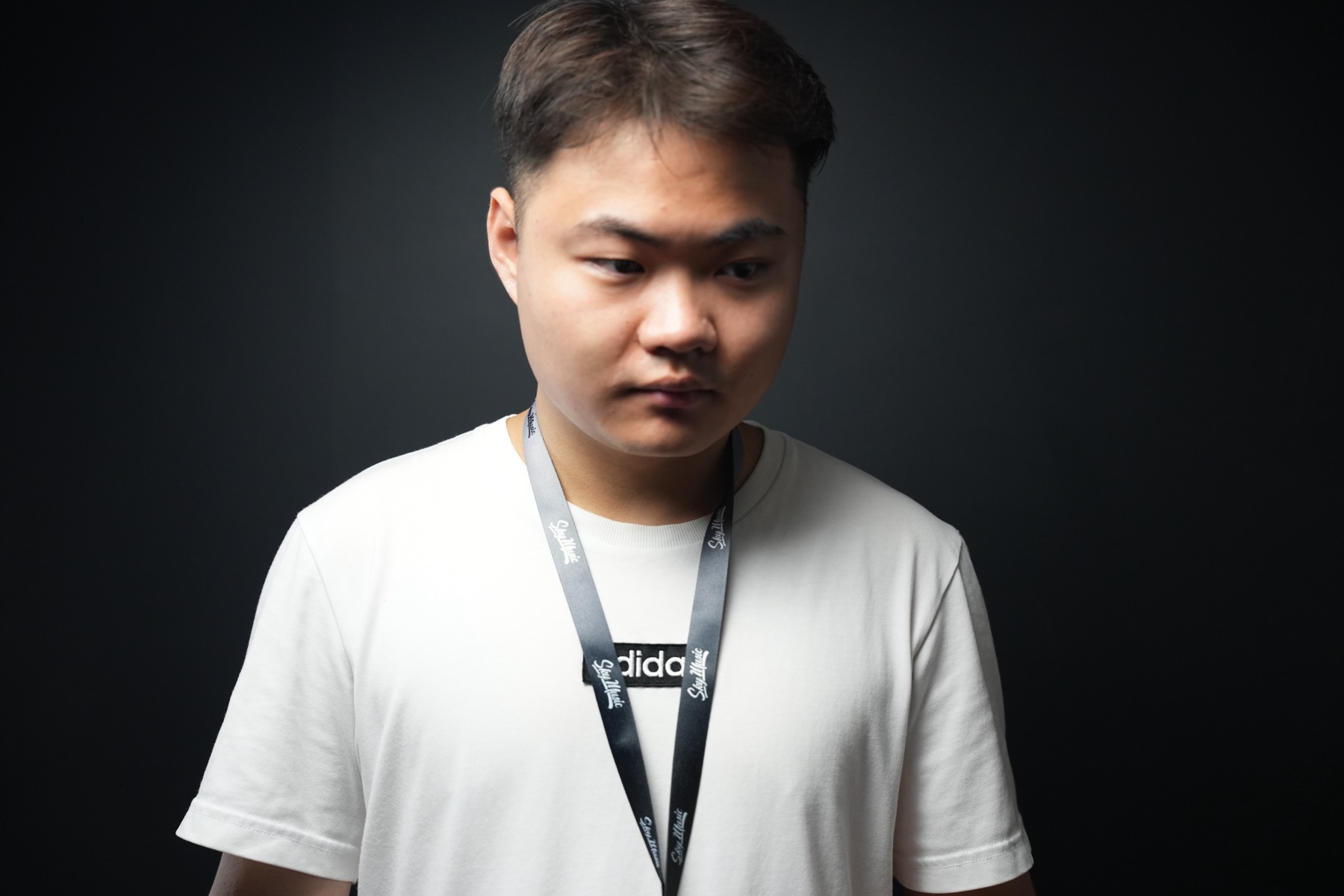 Bronx Wang portrait against a dark wall